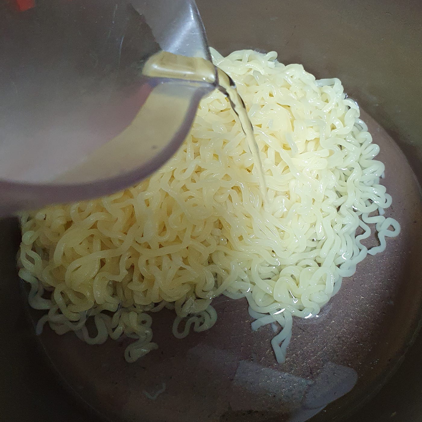 Adding 200ml (1/5 cup) of cold water to the noodles from a package of Wicked Ramen (Yogoe Ramyeon) Shinsadong Naengcho-Myeon Flavor.