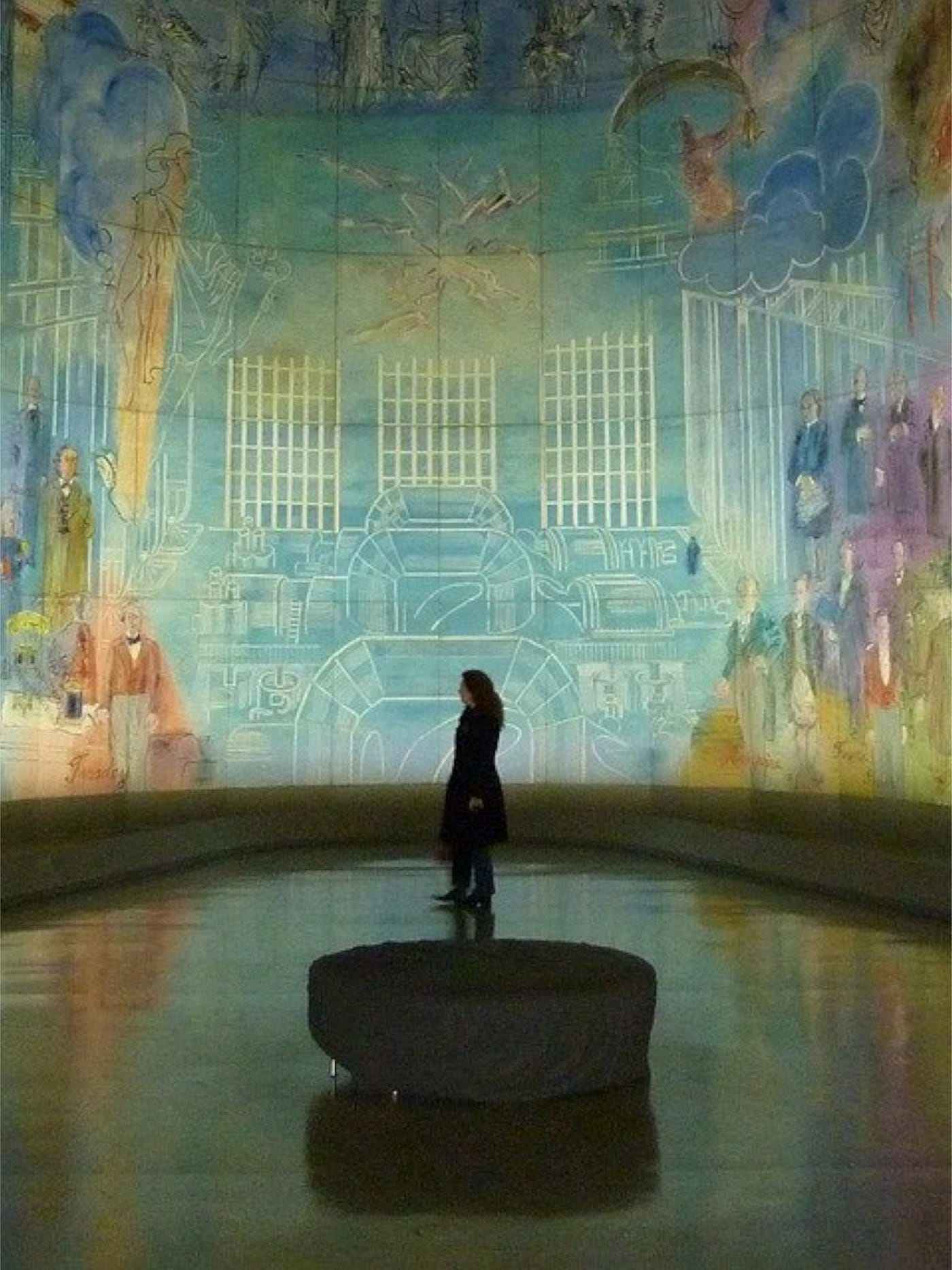 Color photo of a large surrounding gallery of a mural work of art.