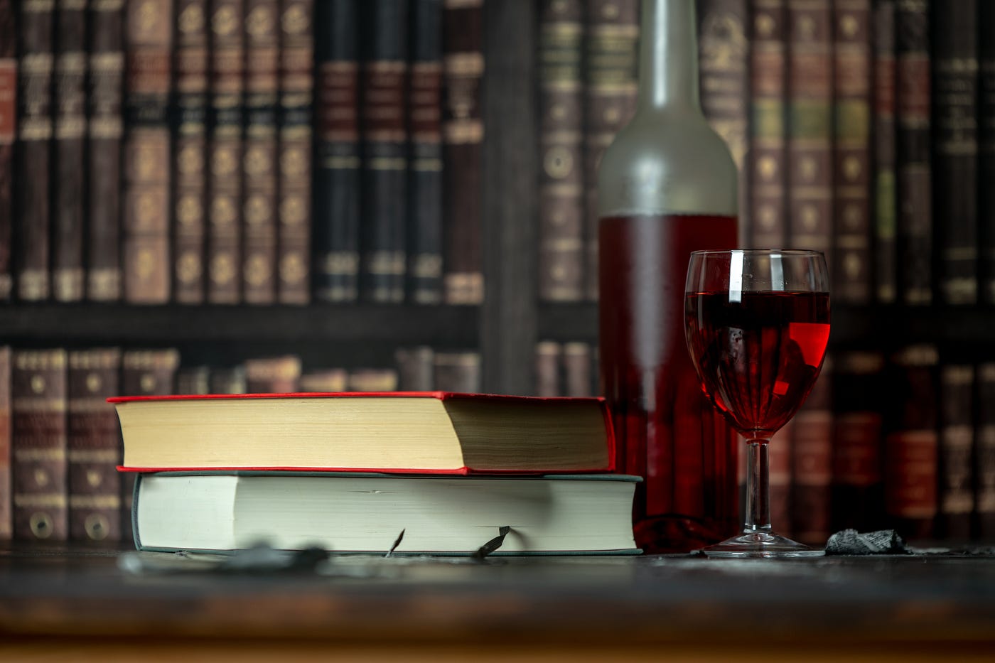 Red wine and books in background