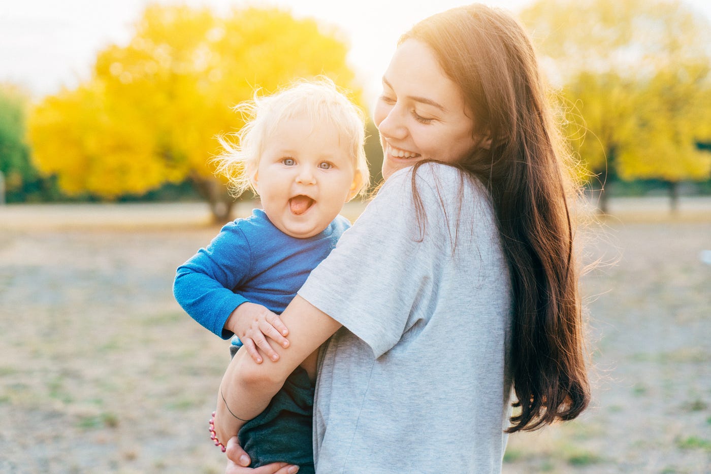 Person holding smiling baby.
