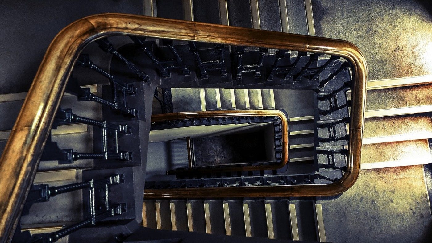 Color photo of an extensive winding staircase, with numerous flights and landings.
