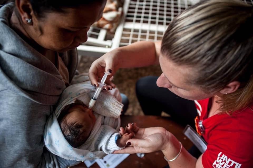 Working with a mother and her baby who was unable to breastfeed, utilizing a special feeding device to help the child gain we
