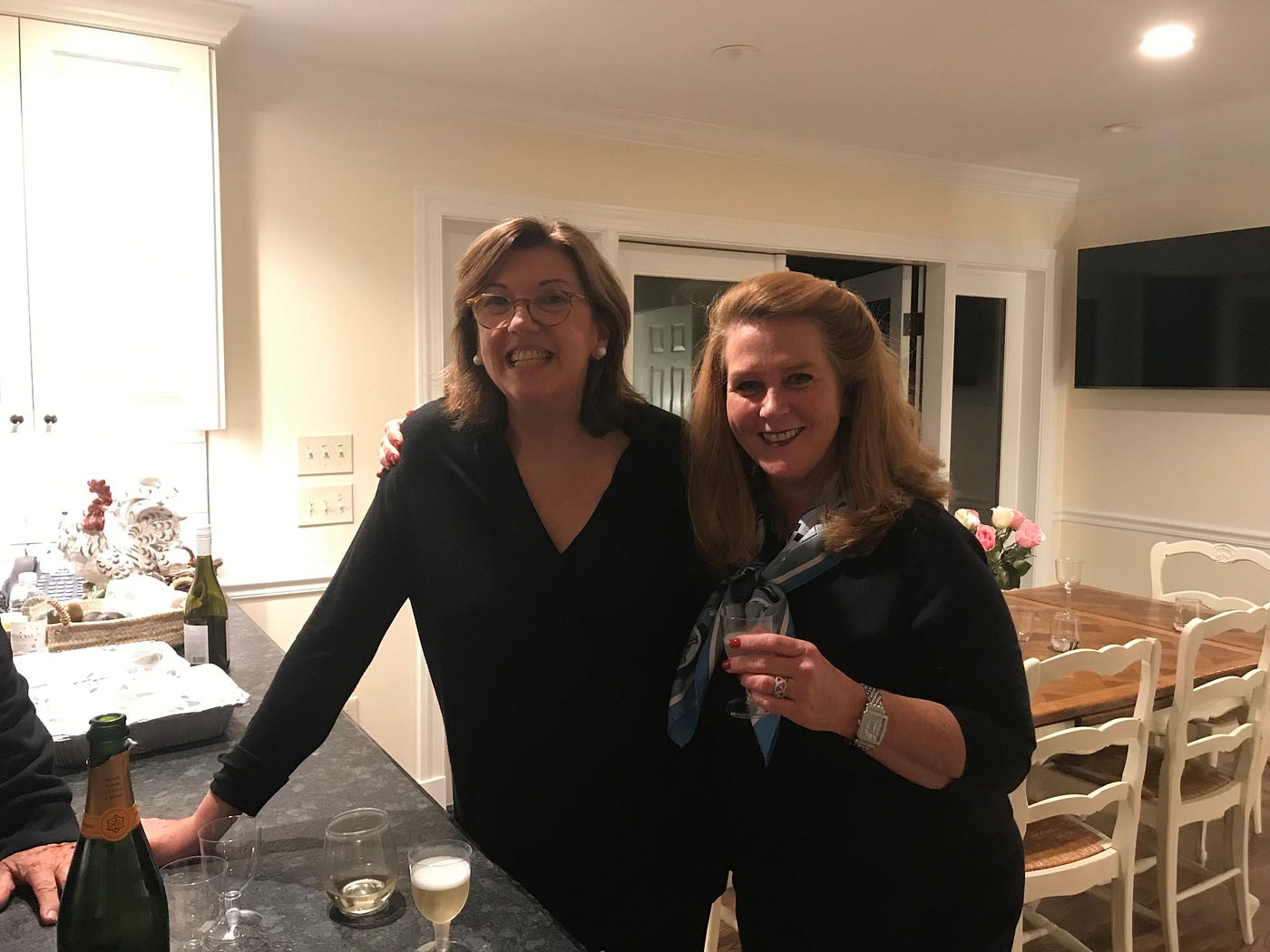 Kendra and a mentor in a kitchen smiling at the camera.