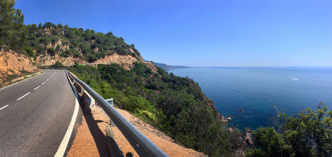 A cliff-edge road on the blue mediterranean sea