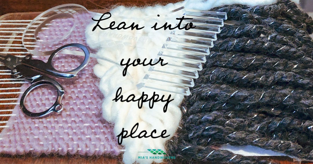 A picture of a woven tapestry wall hanging on an acrylic loom overlaid with the phrase “Lean into your happy place” and the logo for Mia’s Handwovens