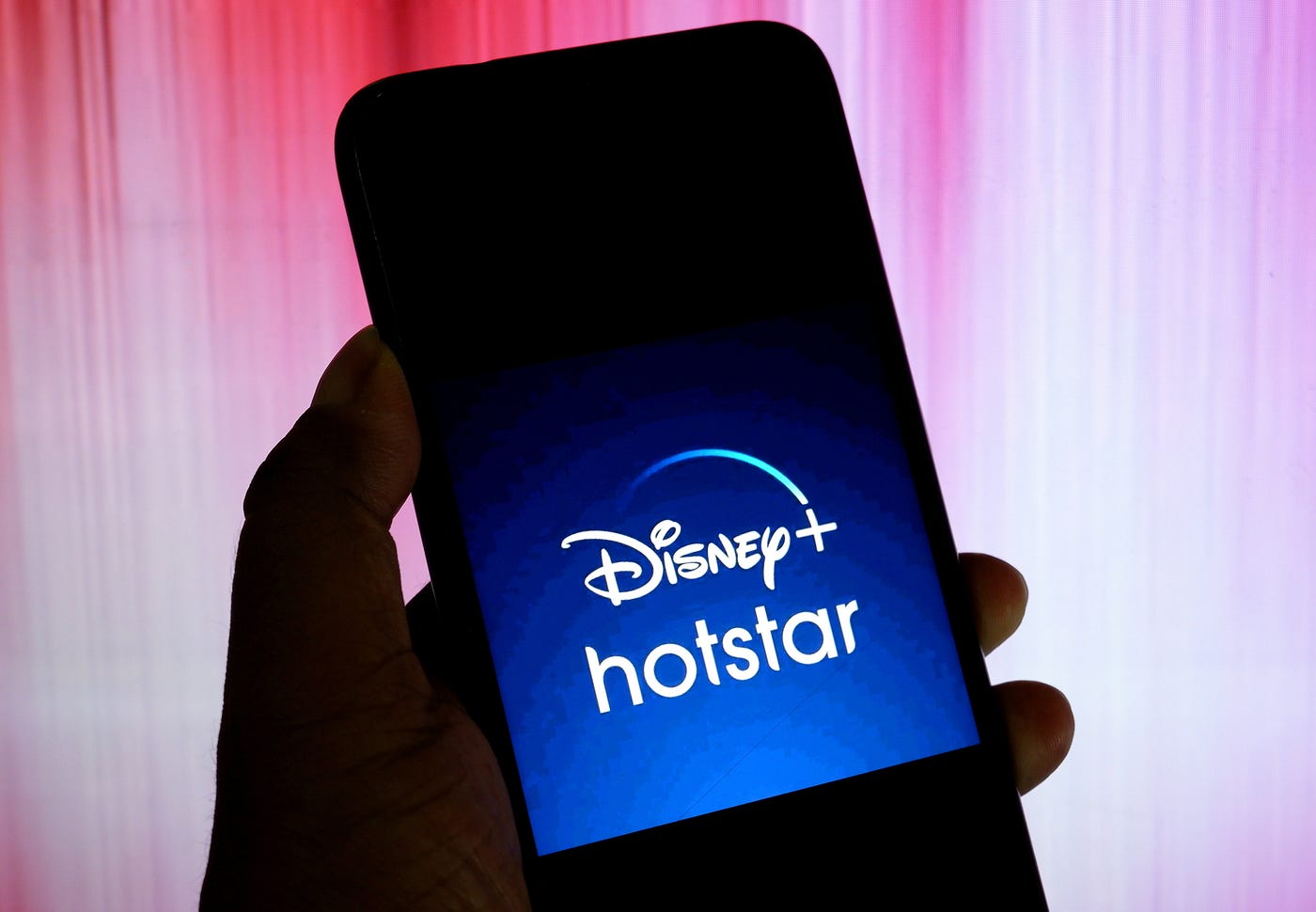 A Disney+ and Hotstar company logo seen displayed on a smartphone