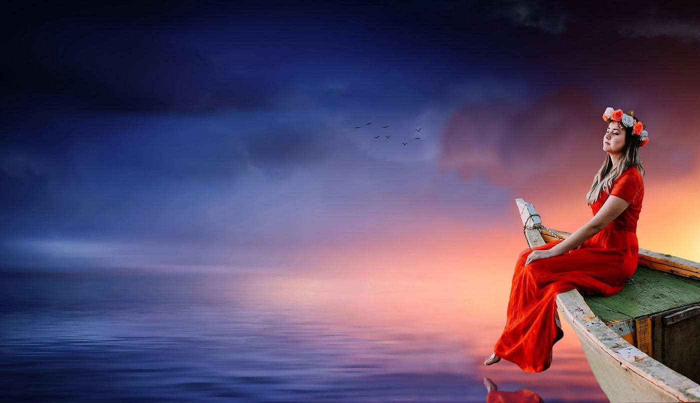 Woman meditating on boat by misty water