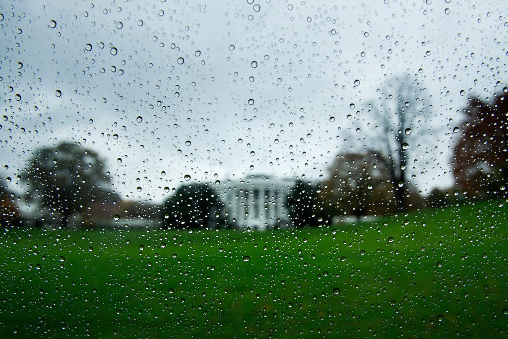Blurry rain-specked view of the White House on a gloomy day.