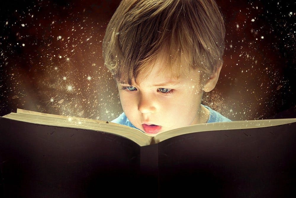A young boy reading a book with sparkles coming out