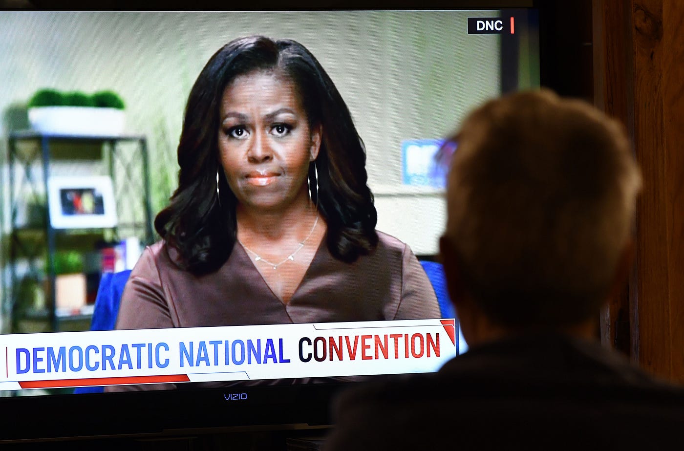 A person watches former First Lady Michelle Obama speak during the opening night of the Democratic National Convention.