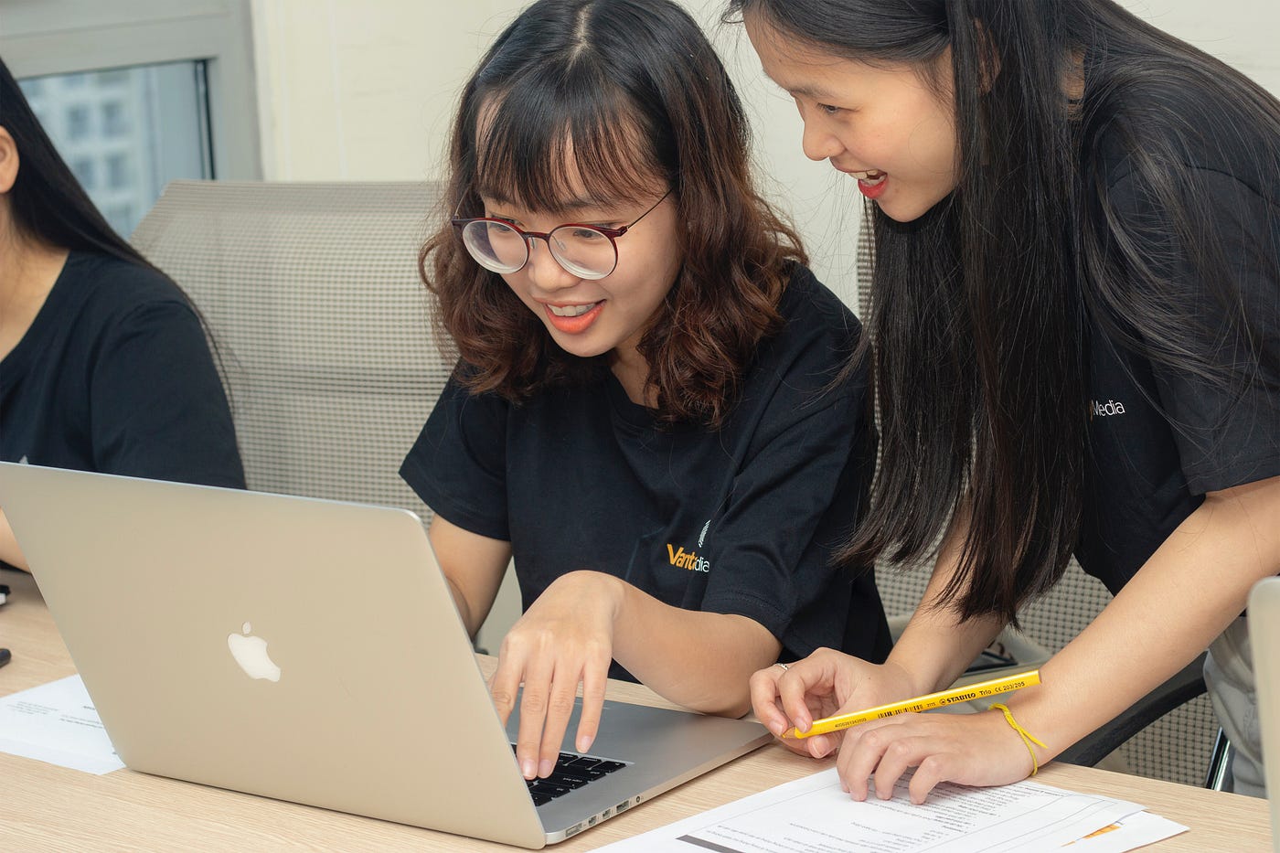 Students using a laptop.