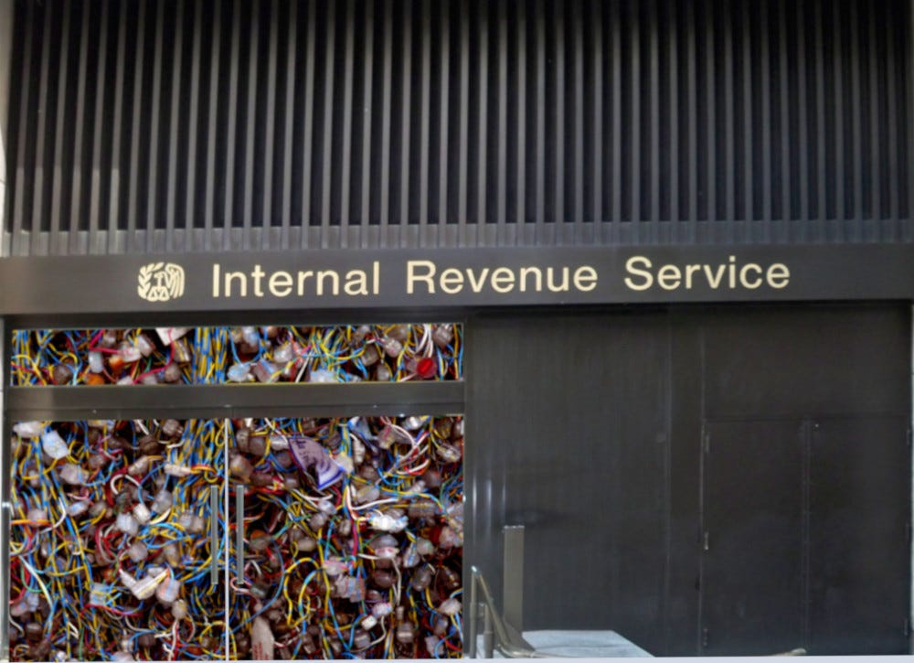 An IRS office, behind the glass doors are an impossible tangle of telephone wires. Image: Matthew G. Bisanz (modified) https://commons.wikimedia.org/wiki/File:NYC_IRS_office_by_Matthew_Bisanz.JPG CC BY-SA: https://creativecommons.org/licenses/by-sa/3.0/deed.en