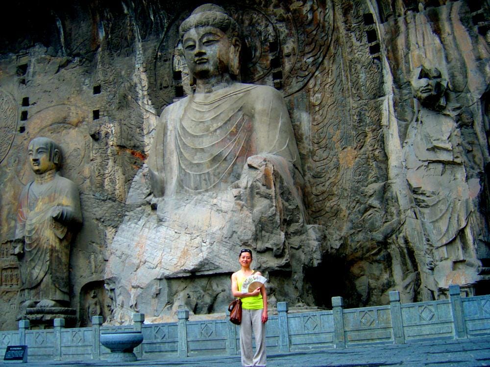 Gigantic stone Buddha, woman in foreground for perspective