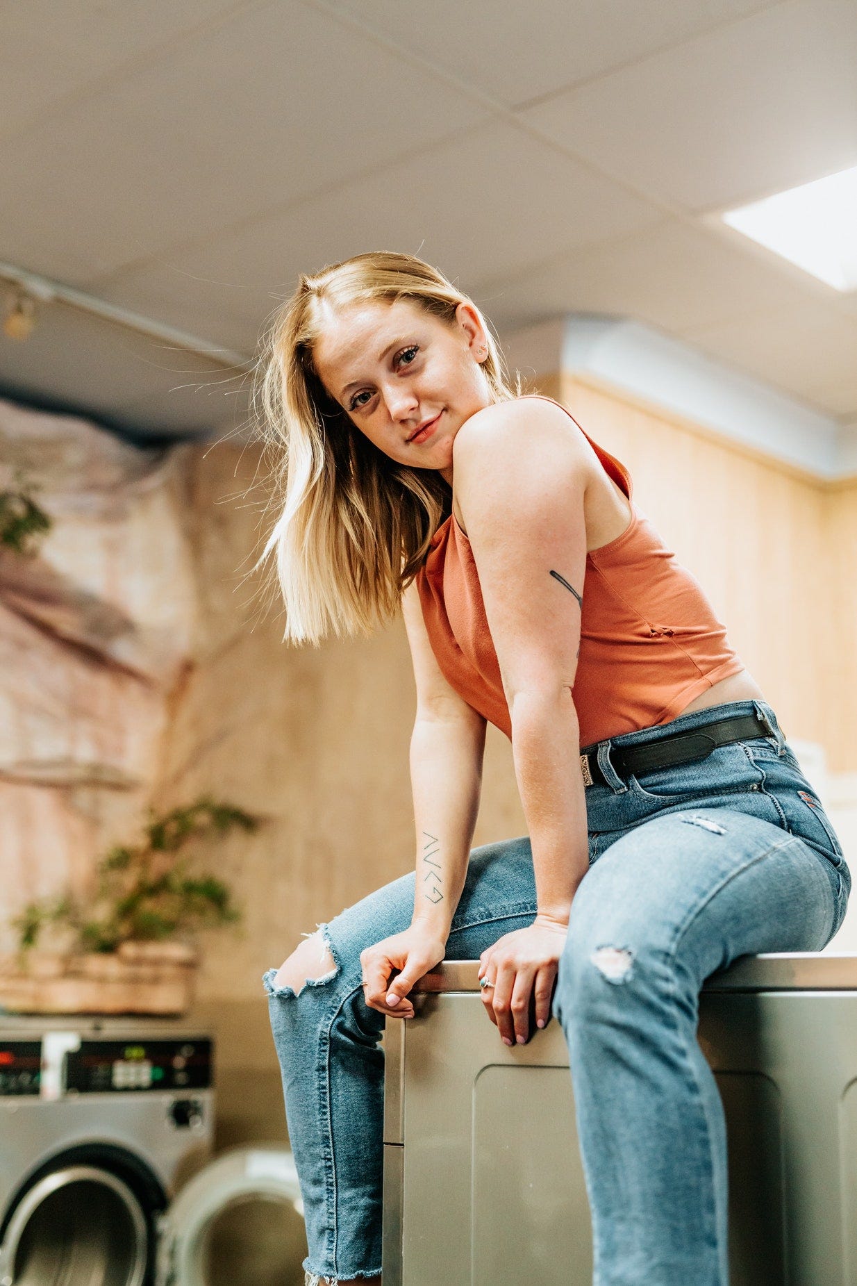 Girl Sitting On Washing Machine