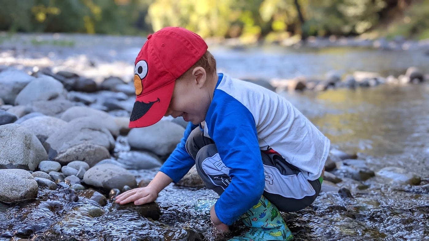 Child plays in a creek.