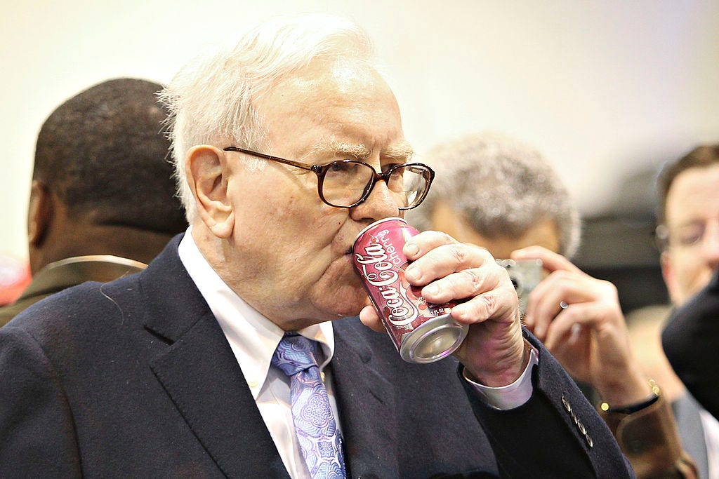 Warren Buffett, CEO of Berkshire Hathaway, drinks a Cherry Coca-Cola as he tours the exhibition floor prior to the Berkshire Hathaway annual meeting in Omaha, Nebraska on May 1, 2010