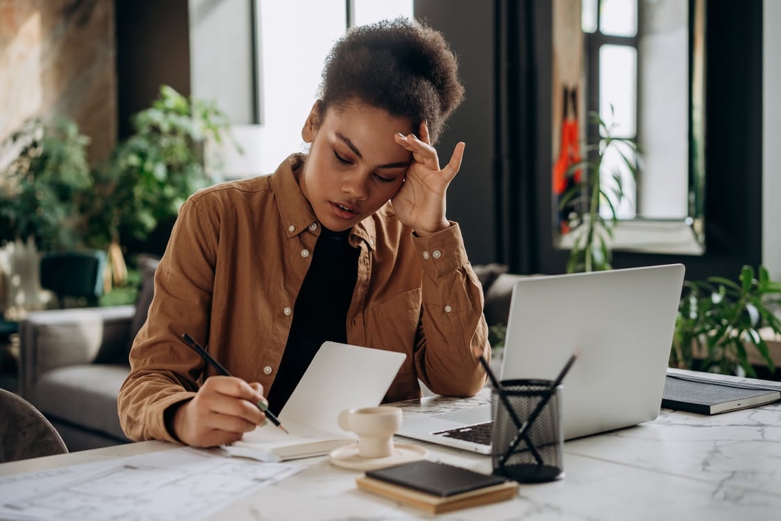 Picture of a woman taking some notes.