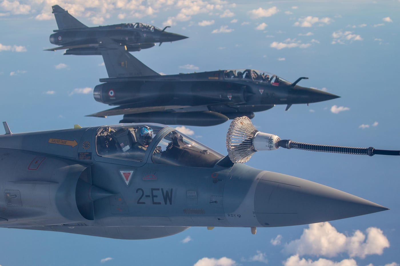 An image of three French Mirage fighter aircraft aerial refuelling over Europe.