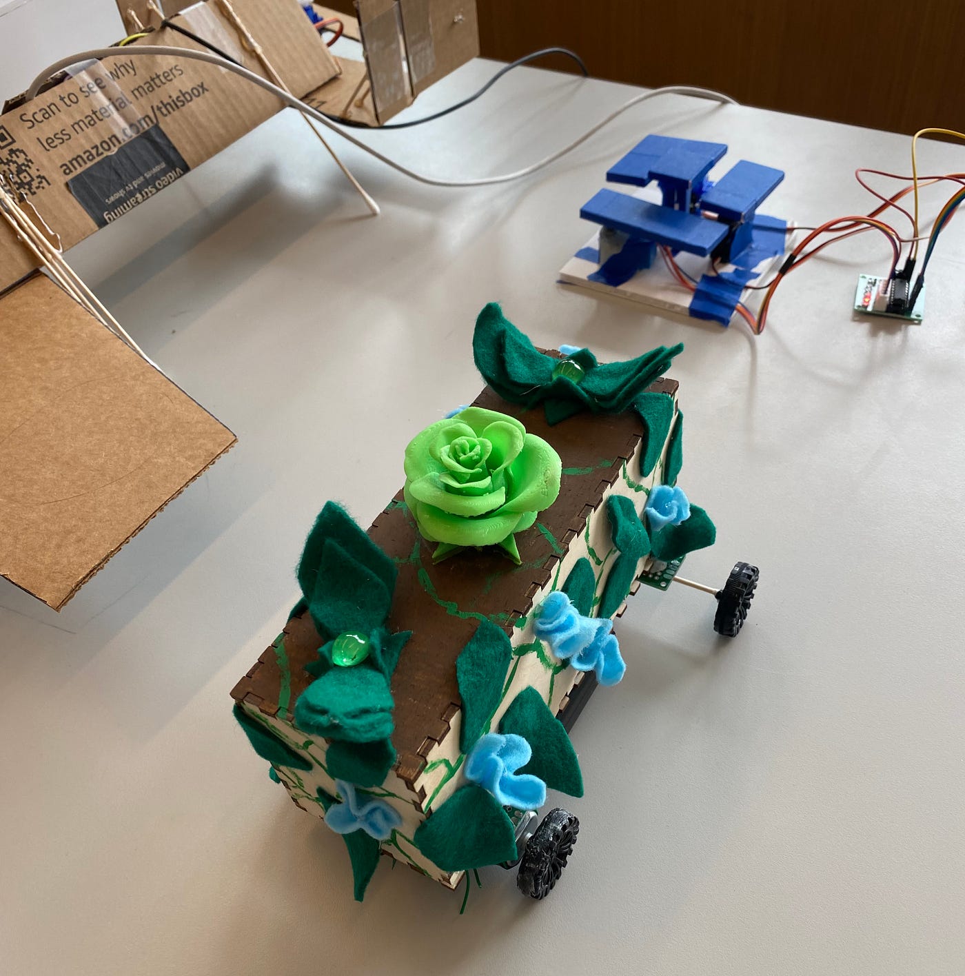 Miniature parade float with a rotating green flower and spinning leaves
