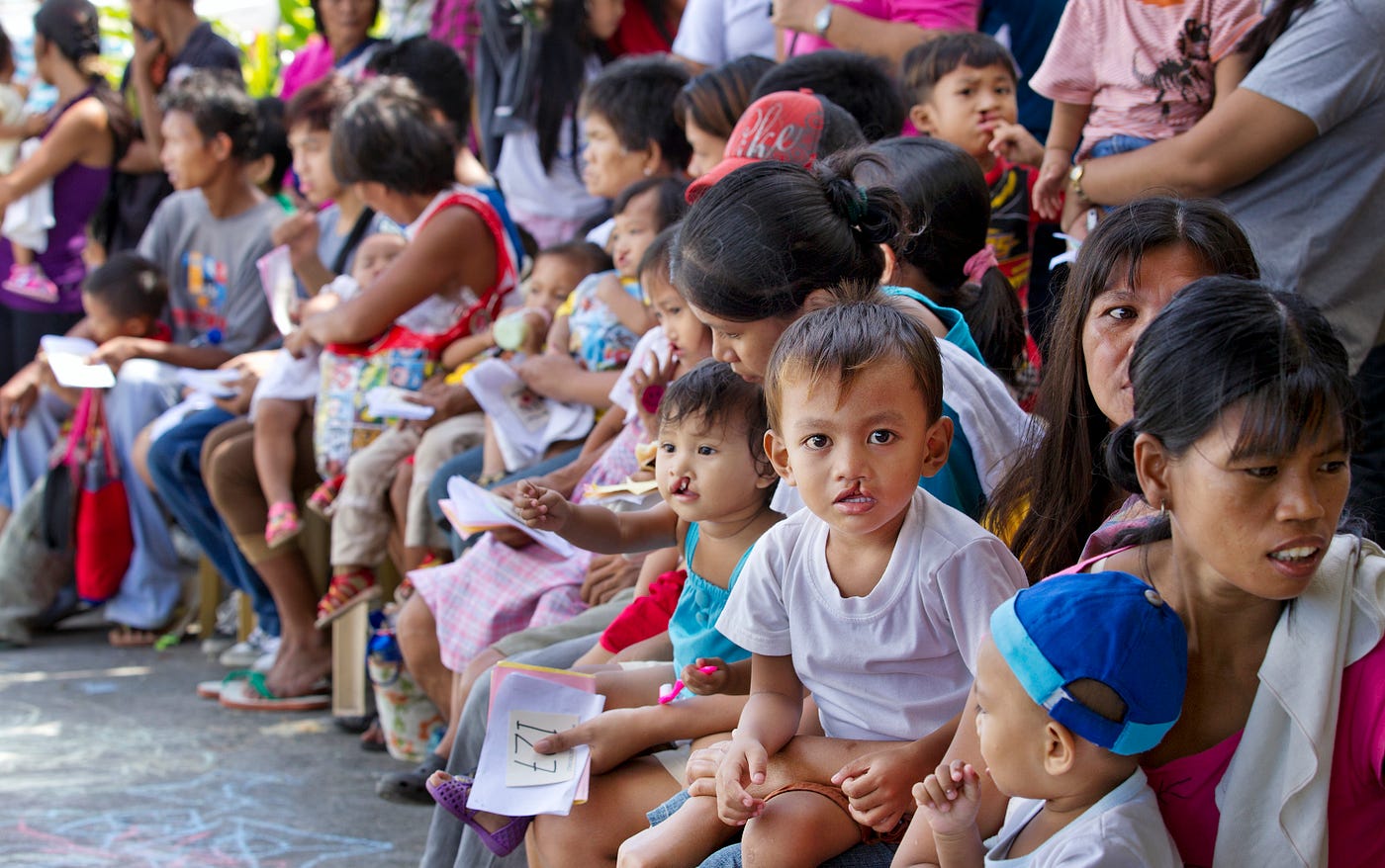 A crowd of families waiting for a health screening at an Operation Smile mission in the Philippines