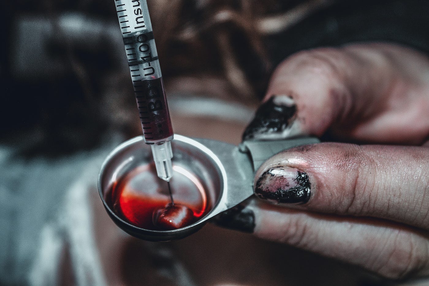 Shows a needle sucking up heroin for a heroin addict