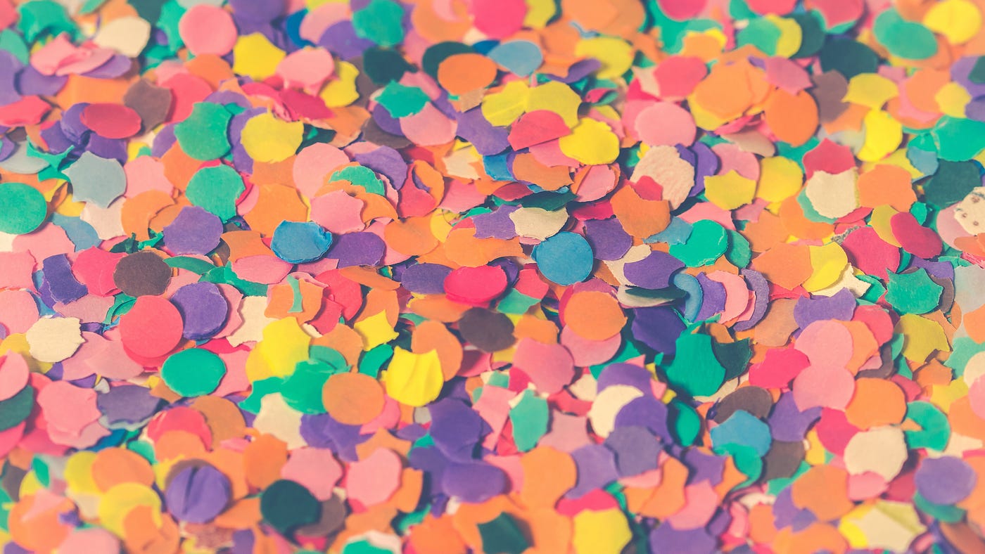 A pile of multi-colored paper confetti circles.