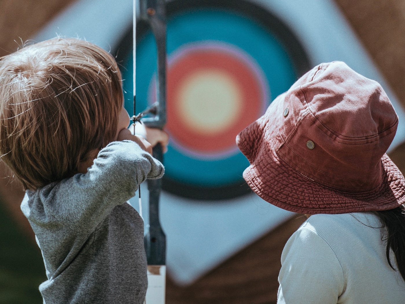 Woman and Child with bow at archery target practice
