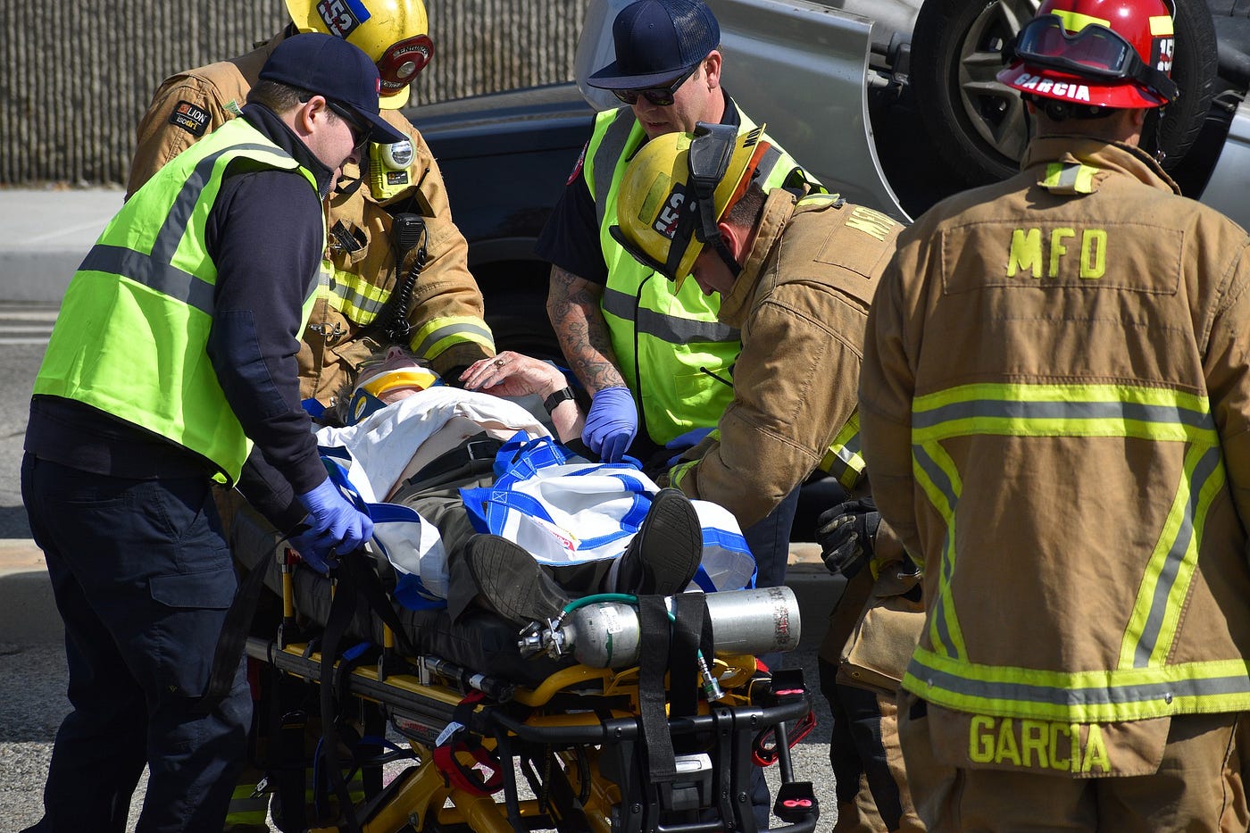 First responders move a person on a gurney