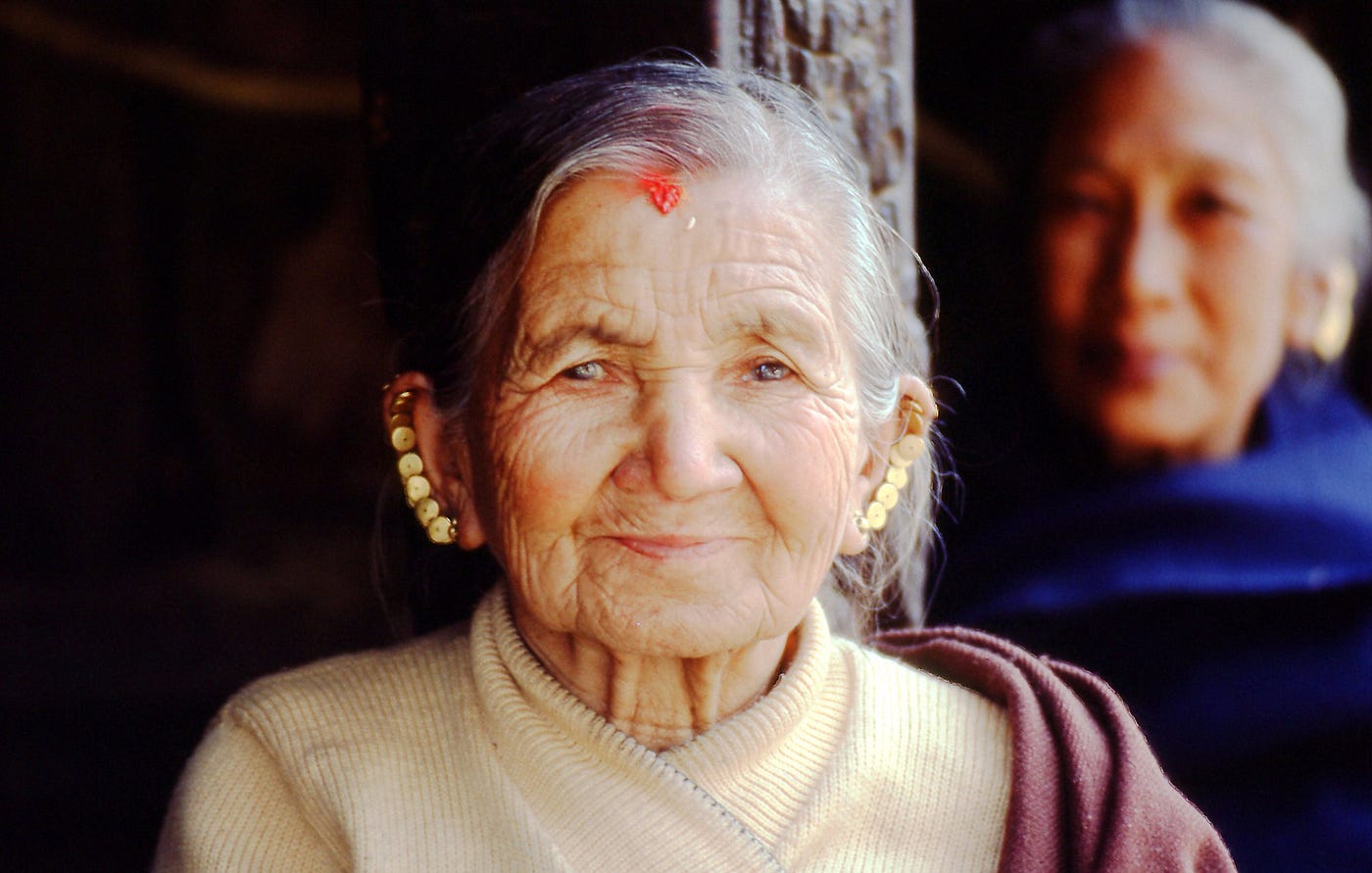Wise old woman, wise young woman in background