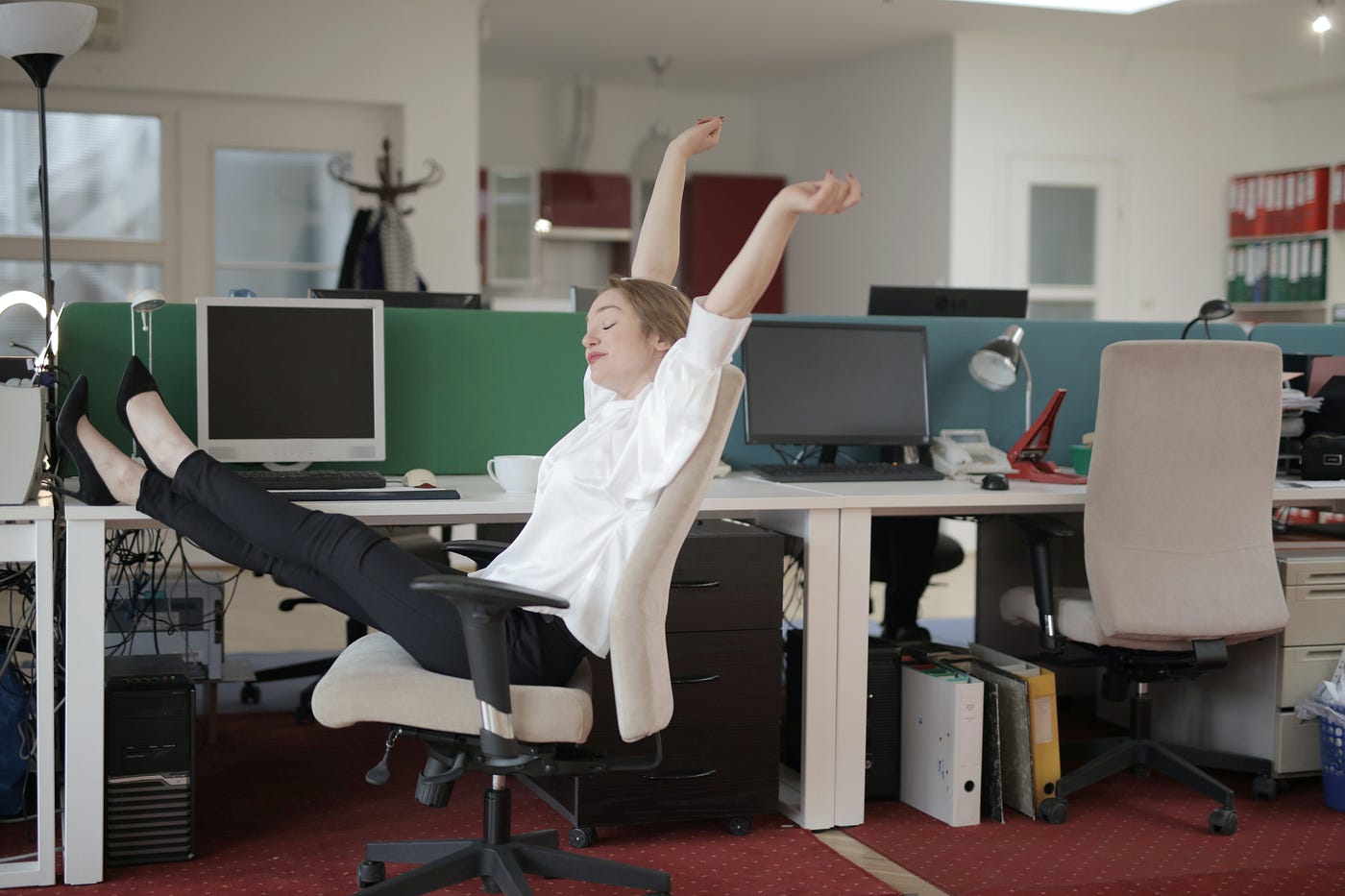 person relaxing in empty office