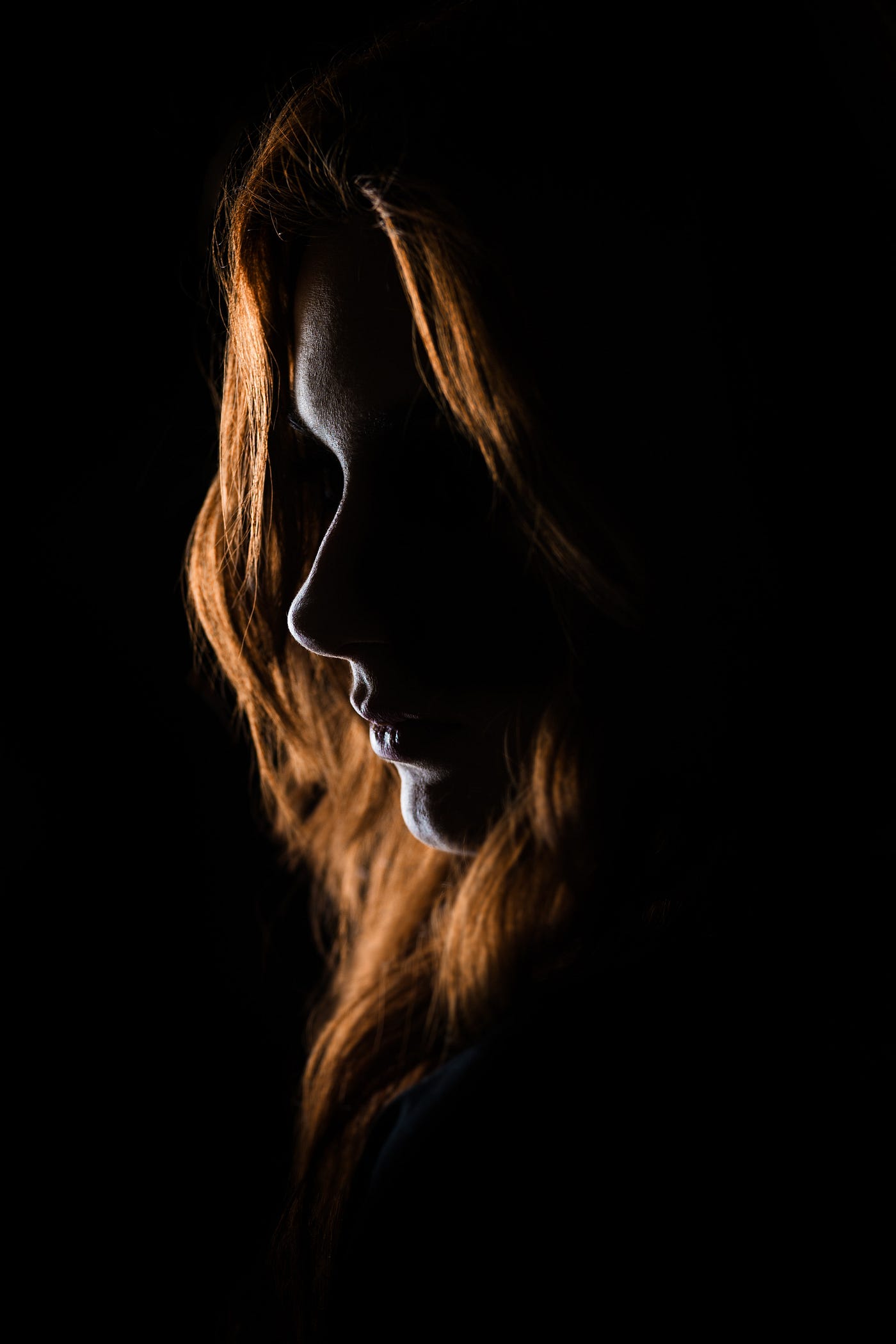close up of a woman’s face in shadow
