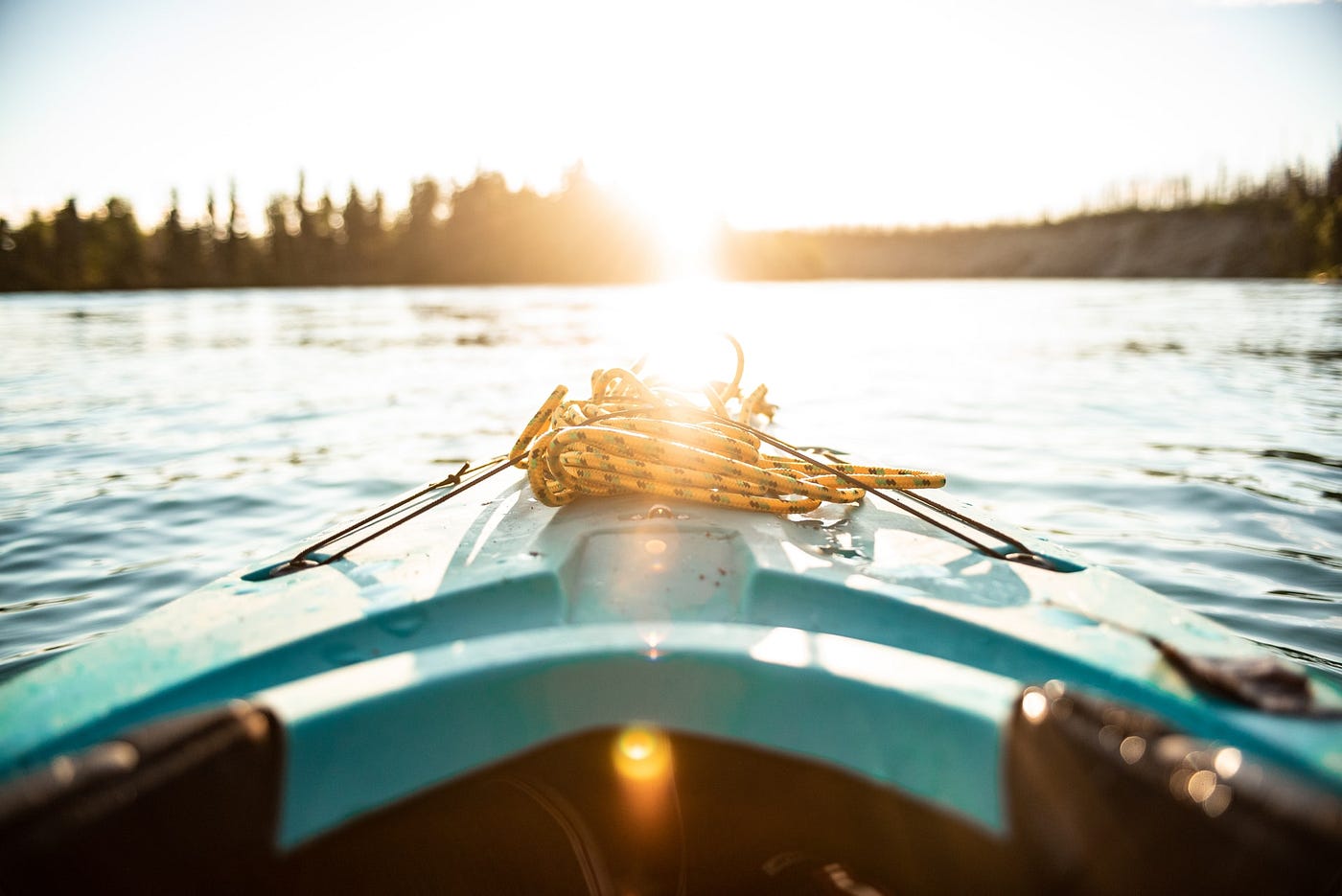 Boat on lake with sunlight reflecting on water