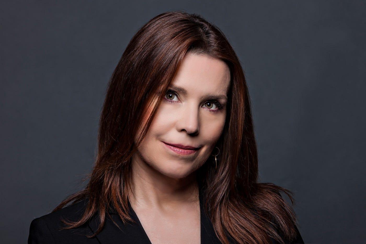 Photo of Annie Duke against dark background