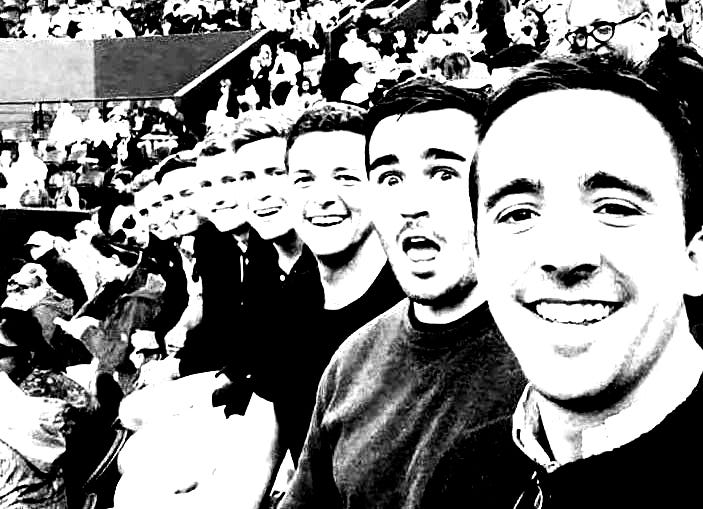 A line of white men, smiling.