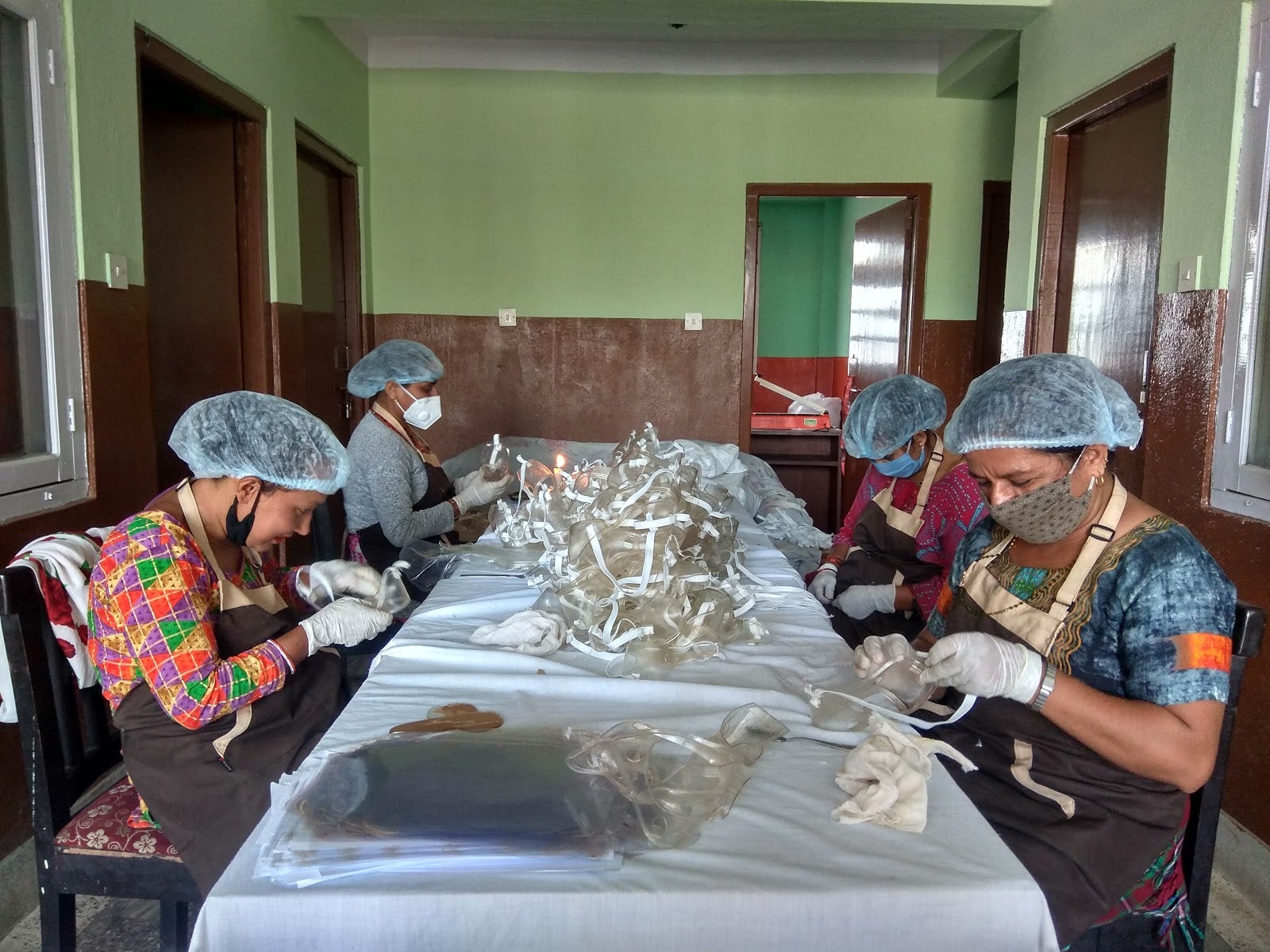 Women working on the assembly of safety goggles