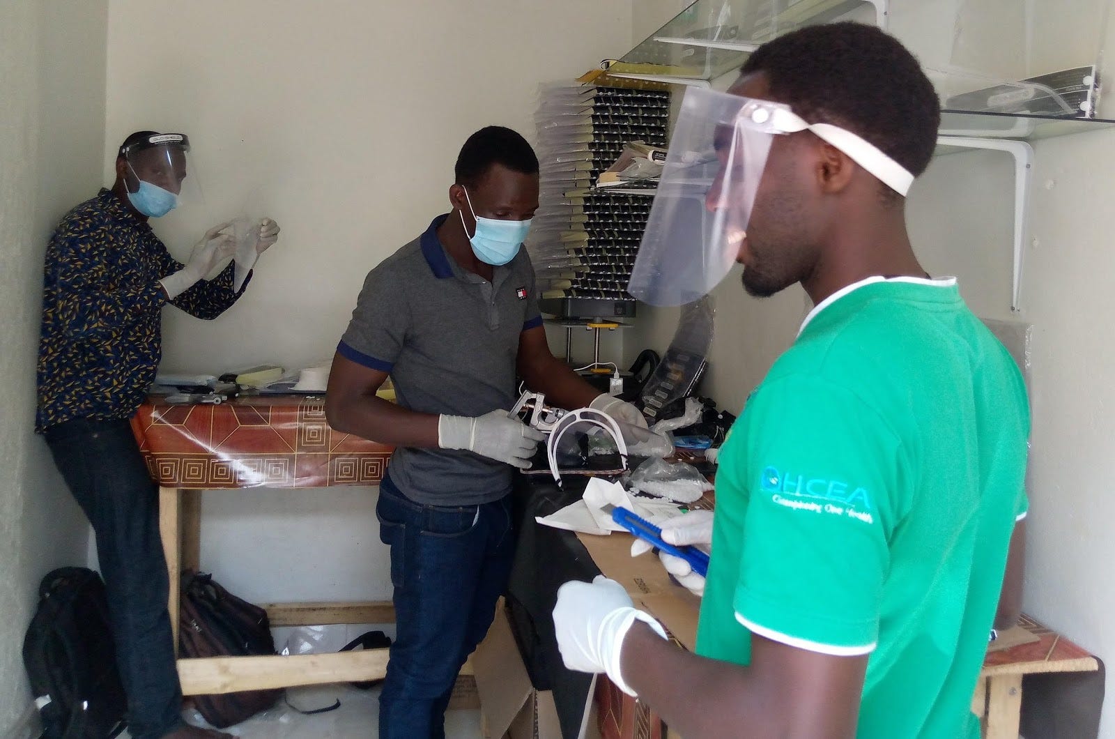 Three people who are GAS team members making face shields in a workshop