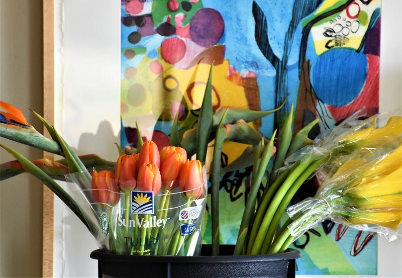 Bright colored modern art painting with flowers in matching colors preparing for a Historic Garden Week house tour