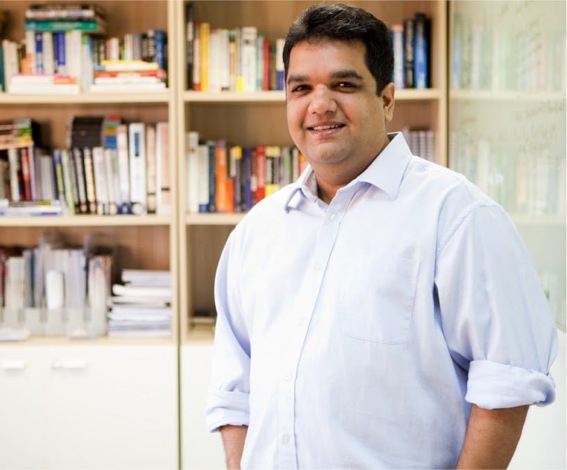 Akshay Shah, Group Executive Director of SilAfrica, standing in front of a bookcase