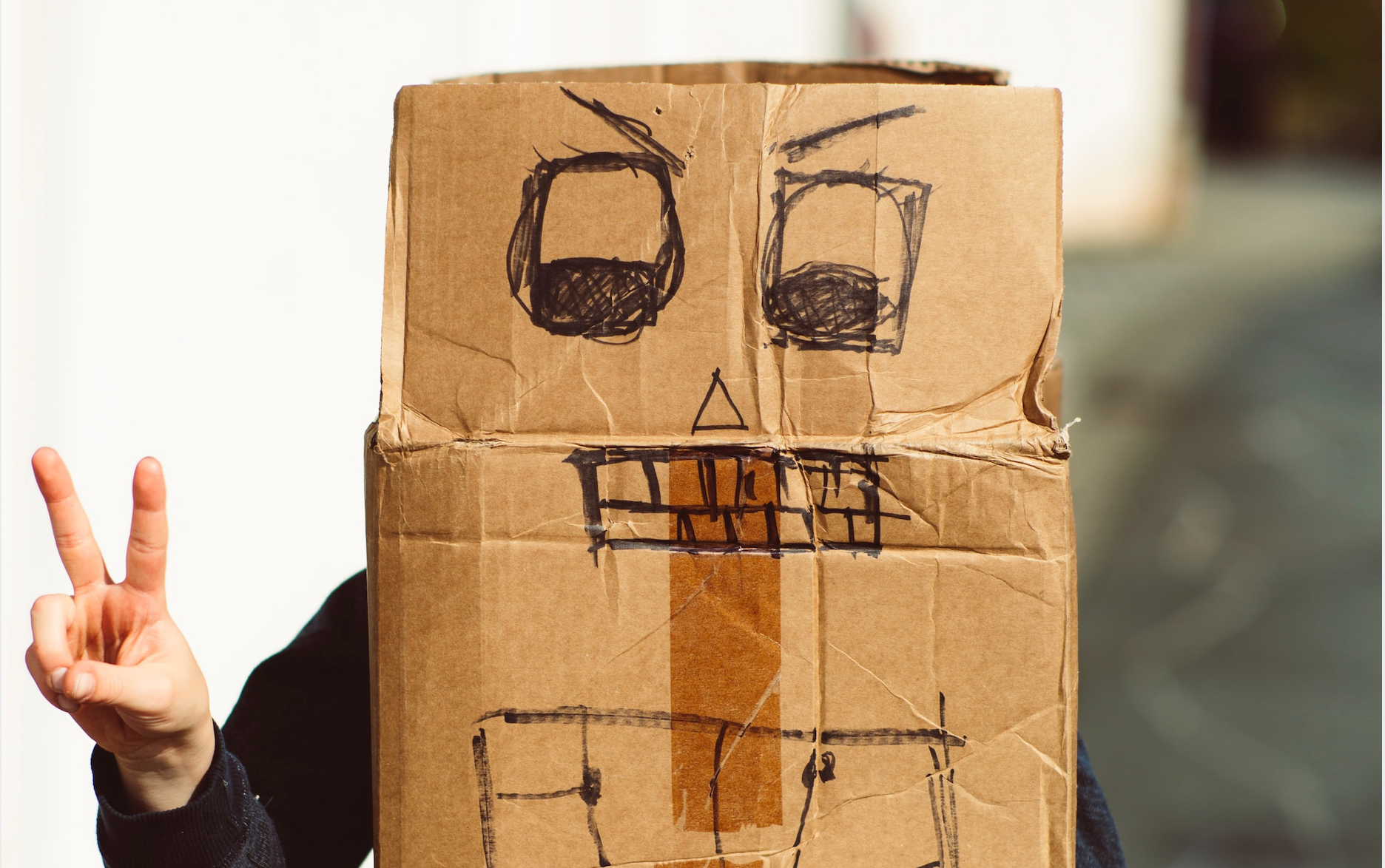 boy making a costume from a cardboard box