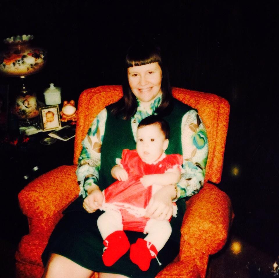 An older photo of a mother and her infant daughter.