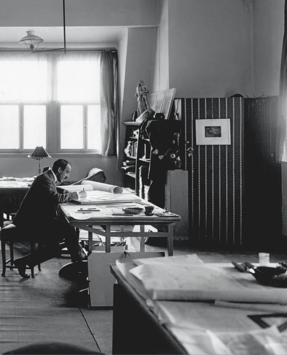 Henry van de Velde, architect and artist, sits in a large room alone.