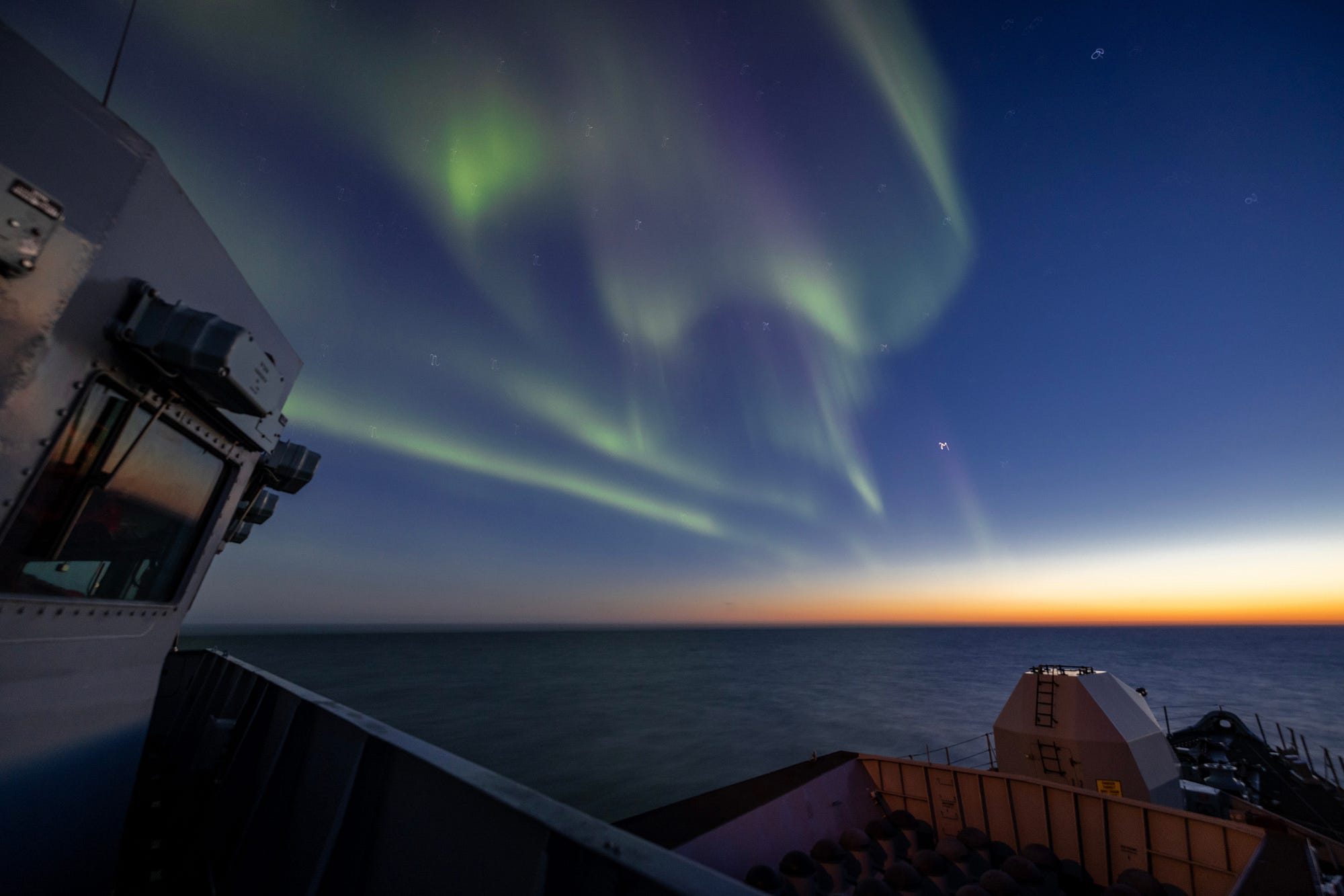 HMS Lancaster takes in the stunning lights display in the Arctic.
