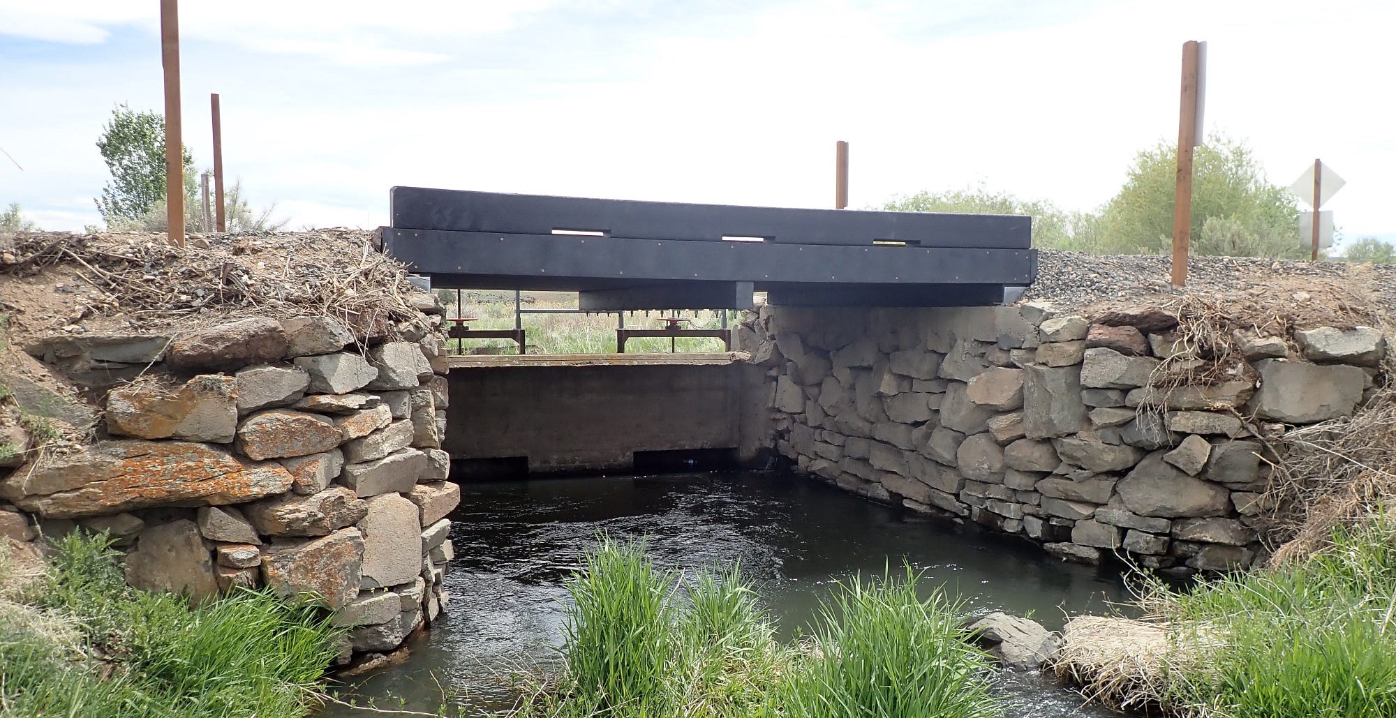 The 16-foot thermoplastic structure carries vehicle and foot traffic across Bridge Creek on East Canal Road. The span is made from 100% post-consumer and industrial recycled plastic.
