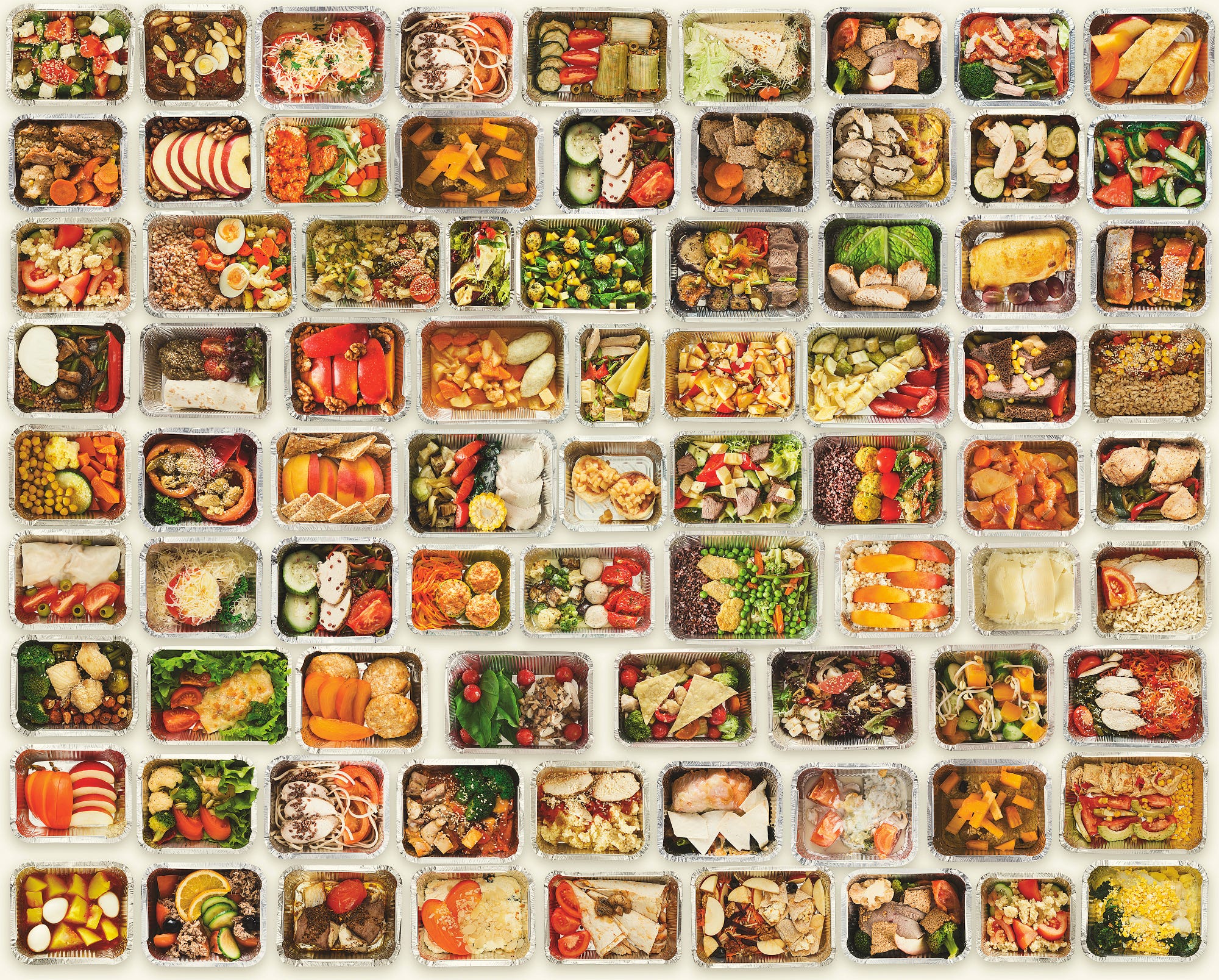 A set of a variety of healthy foods in take away food boxes against a white background.