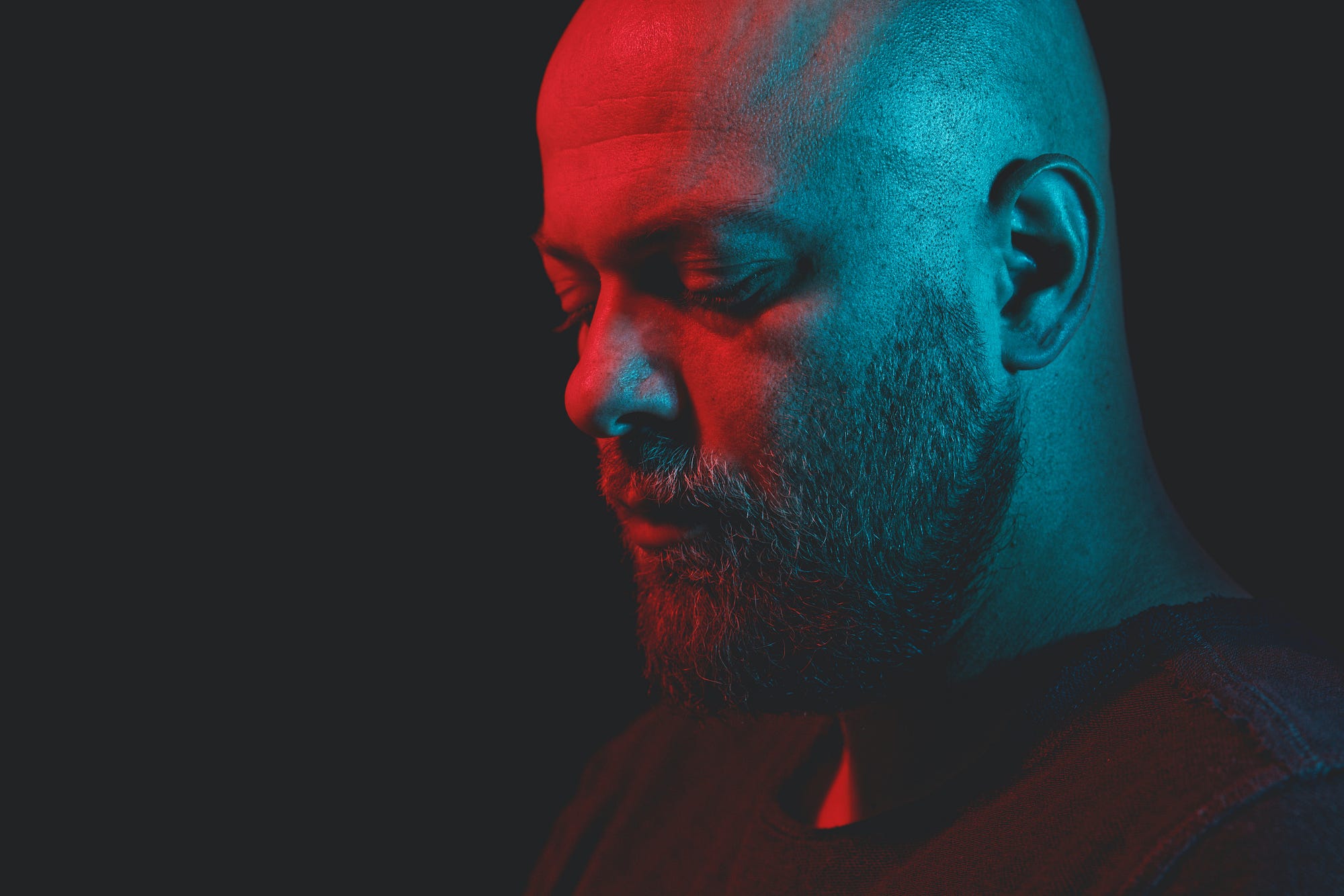 7 Powerful Habits That Can Help You Stop Living in the Past — portrait of old man with illuminated face in red
