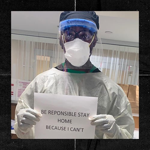 Dr. Patrik Charles wearing PPE and holding a sign “Be Responsible Stay Home Because I Can’t”