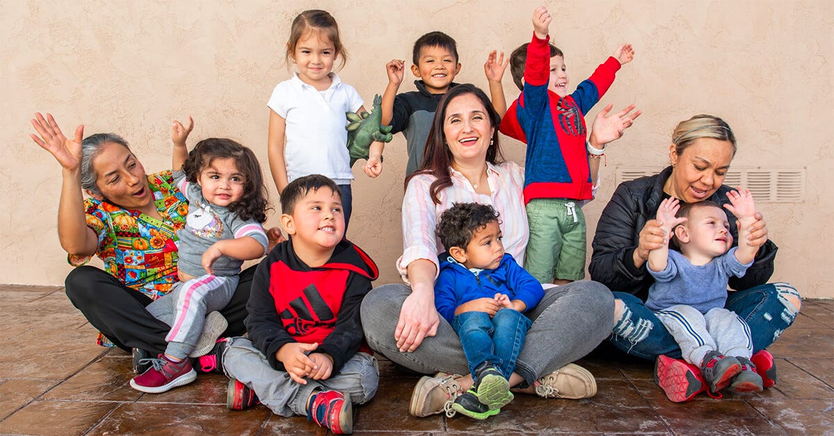 Child care provider Miren Algorri surrounded by children and her co-workers.