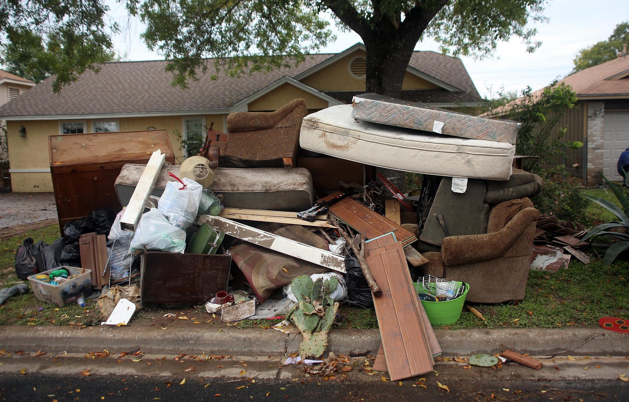 Personal home belongings, destroyed by flood waters, line residential streets during clean up.