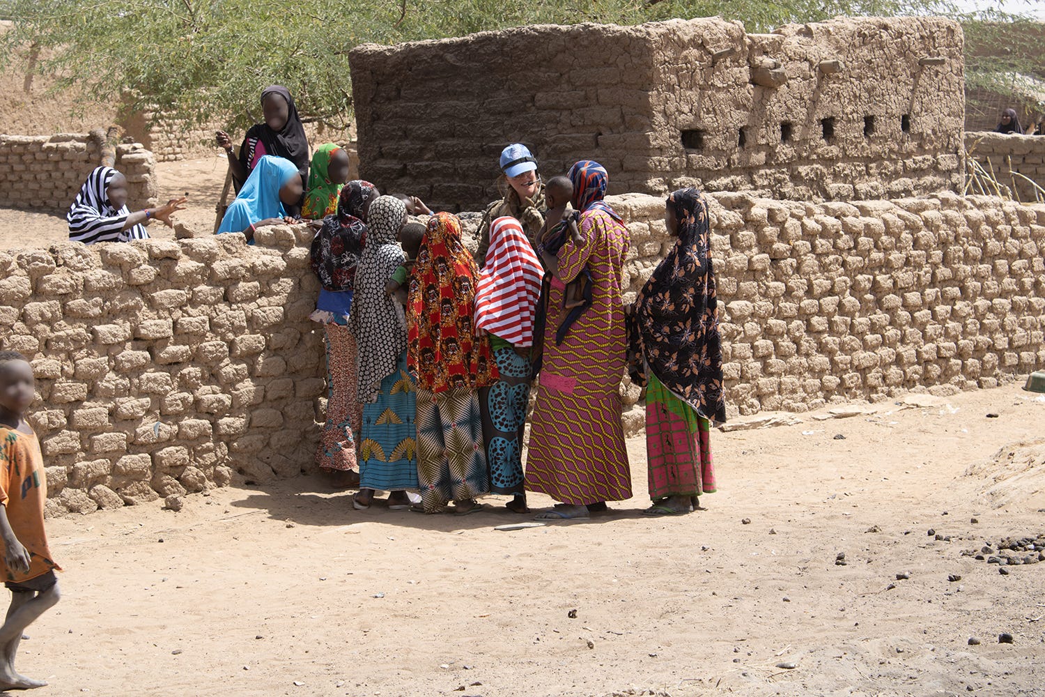 A British peacekeeper talk with locals while out on patrol in Mali.