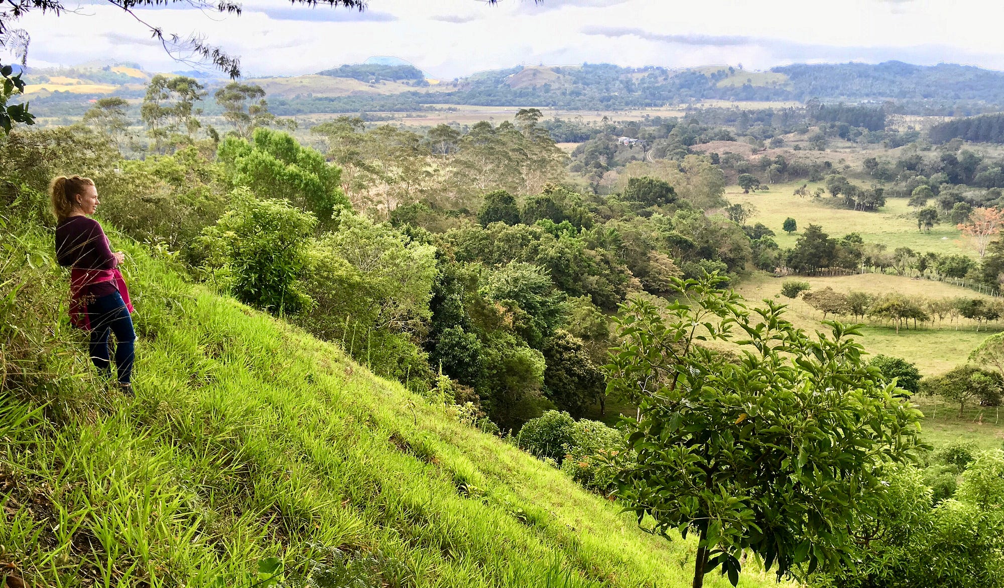 Rebecca Murauskas stands on Boquete Panama hill. Benefits of quitting job living internationally Expat life Move abroad FIRE